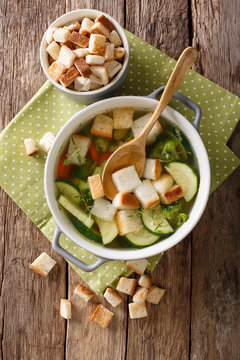 Vegetarian vegetable soup with croutons and thyme close-up in a bowl. Vertical top view