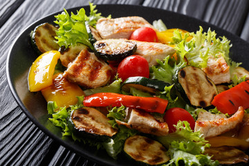 Salad with grilled chicken breast and summer vegetables closeup on table. horizontal