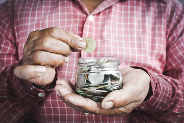 Old hands holding coins selective and soft focus vintage tone