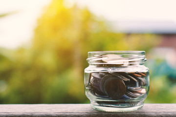 Close up  coin on wood and tree bokeh background selective and soft focus hipster tone