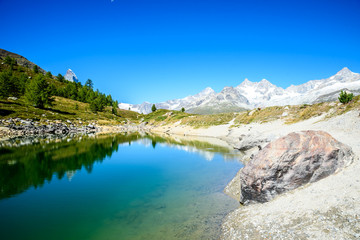 Gruensee (Green lake) with view to Matterhorn mountain - trekking in the mountains near Zermatt in Switzerland