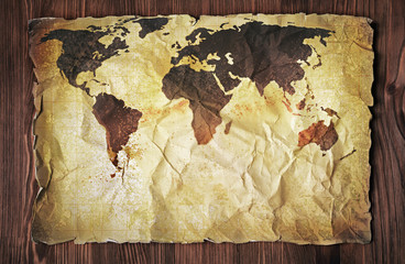 Yellow retro stained paper with old vintage map of the world