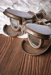 Obraz premium Close-up view of a vintage binoculars and an old paper sheet