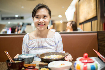 Asian woman select menu for order