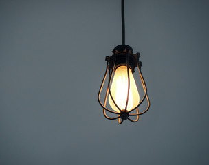 Yellow illuminated hanging light bulbs on plain navy background with free text space