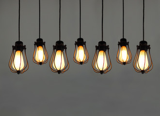 Beautiful hanging light bulbs on plain background for card, banner, wallpaper