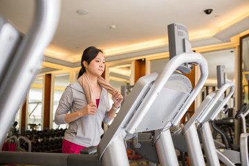  Asian woman running with machine walking