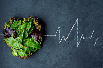 Healthy eating healthy heart cardiogram. Medical background . Fresh herbslaid out in the shape of a...