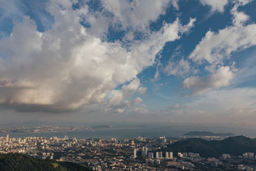 Cloudy sky, cityscape and mountain with green that viewed from Penang Hill at George Town. Penang, Malaysia.