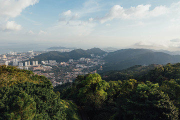 Fototapeta na wymiar Cloudy sky, cityscape and mountain with green that viewed from Penang Hill at George Town. Penang, Malaysia.