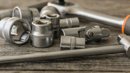 Spanner head and power wrench on a wooden table in the workshop