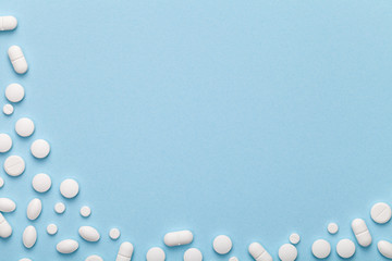 White Medical Pills on Blue Background