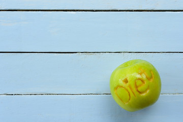 Apple carving character diet on blue background.Top view