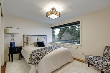 White bedroom furnished with iron bed