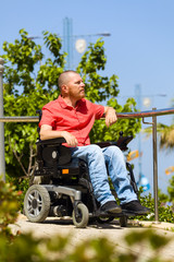 Disabled person on wheelchair dreaming at the park