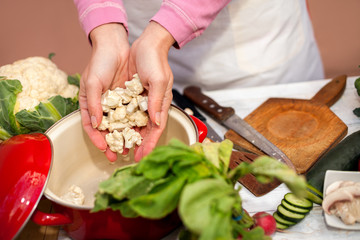 Woman holding slices of cauliflower in her hands
