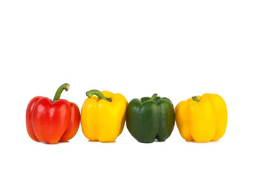 Four sweet peppers red, yellow and green on isolated white background