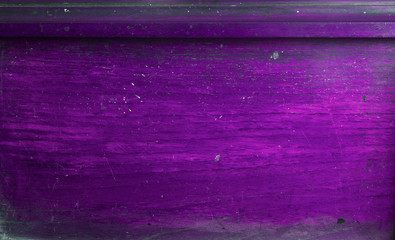 Scratched, scuffed and faded purple wooden background texture.