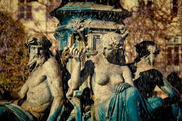 Fototapeta na wymiar Sculptures at fountain in Rossio Square, Lisbon, Portugal