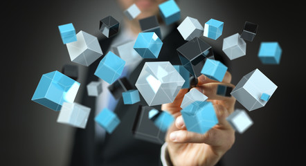 Businessman holding floating blue shiny cube network 3D rendering