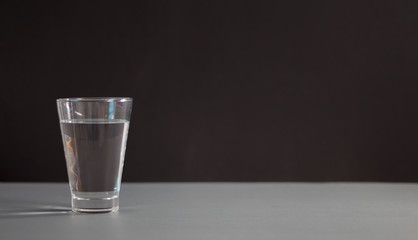 Glasses of water on black background. Healthy nutrition.
