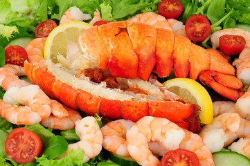 Cooked lobster tails with a fresh salad background