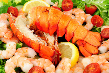 Cooked lobster tails with a fresh salad background