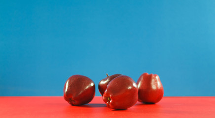 Red apples on background colorful. Copyspace