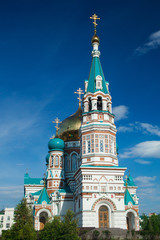 Fototapeta na wymiar Orthodox church under a bright sun in the summer day, blue sky