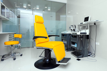 Stylish bright orange armchair in the dentist's office