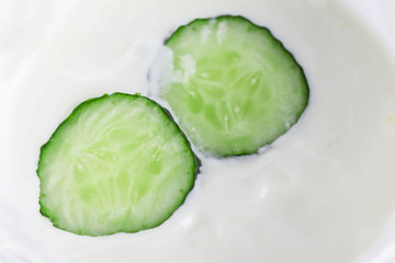 Two pieces of cucumber in white cream