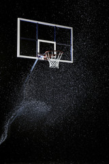 Basketball hoop isolated on black. Basketball arena under rain.