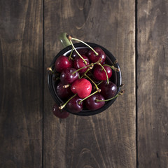Freshly picked cherries on dark wooden table