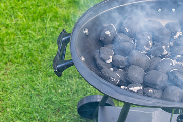 Empty And Clean BBQ Grill Pit With Hot Charcoal Briquettes. Concept For Outdoor Barbecue Party Or Picnic Or Cookout.