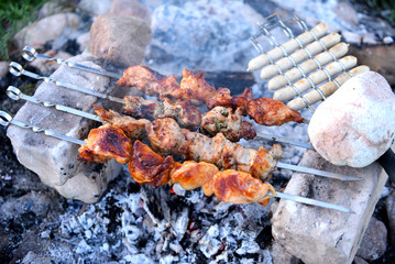 Grilling marinated shashlik on a grill. Shashlik is a form of Shish kebab popular in Eastern, Central Europe and other places. Shashlyk (meaning skewered meat) was originally made of lamb.