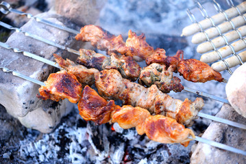 Grilling marinated shashlik on a grill. Shashlik is a form of Shish kebab popular in Eastern, Central Europe and other places. Shashlyk (meaning skewered meat) was originally made of lamb.