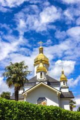 Fototapeta na wymiar Ukrainian Church of the Virgin Dormition against the blue sky. France, Lourdes