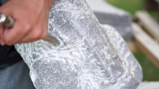 Chiseling a Stone by Hand with a chisel