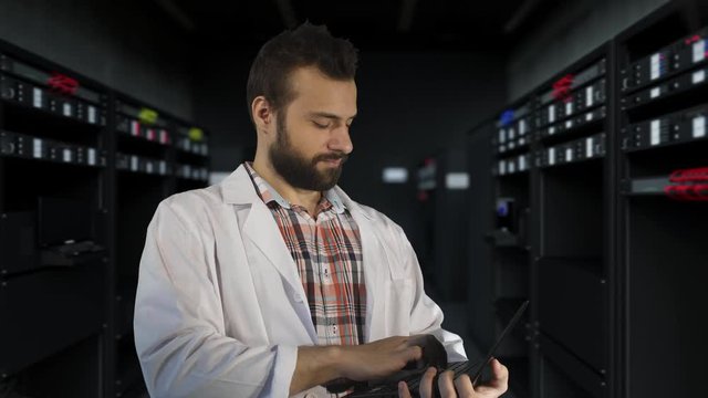 a young scientist working in the server room