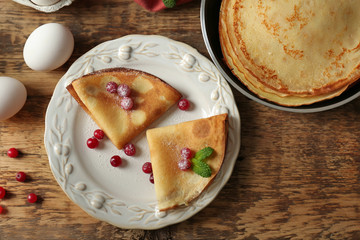 Tasty pancakes with berries on plate