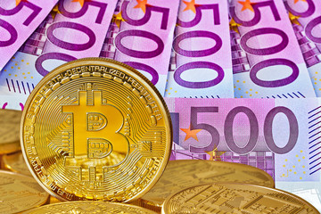 Golden Bitcoins close-up.Background euro currency. Photo (new virtual money ) .Conceptual photo. 