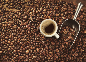Cup of coffee and scoop on beans