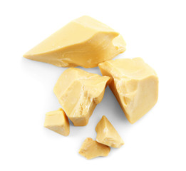 Pieces of cocoa butter on white background