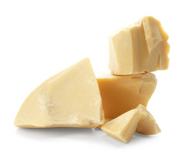 Pieces of cocoa butter on white background