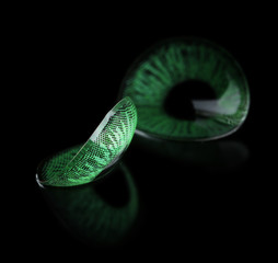 Green contact lenses on black background