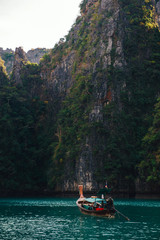 Fototapeta na wymiar Beautiful mountains at the Phi Phi islands. Touristic boats in the sea in Thailand