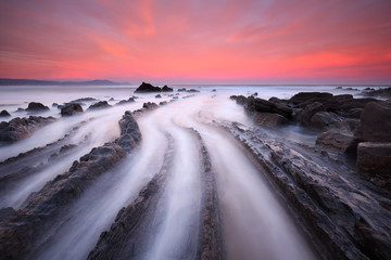 Amazing sunrise over rock formation at Barrika beach (Biscay, Basque Country)