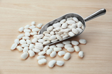 Scoop with butter beans on light background