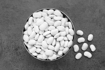 Bowl with butter beans on grey background