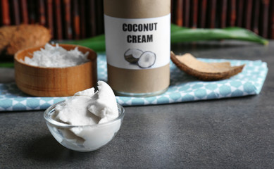Coconut cream in bowl on dark table